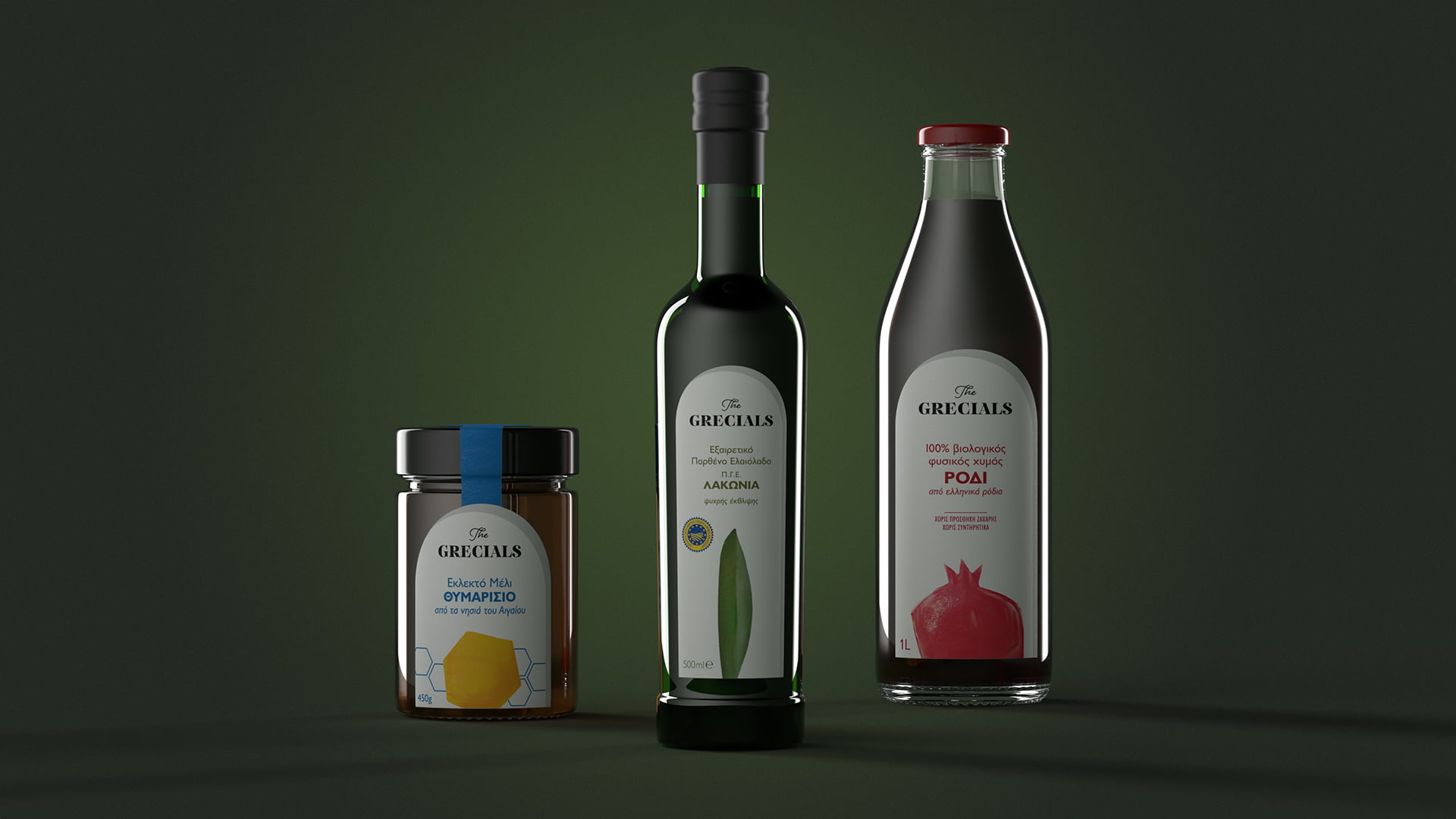 A product grouping of three items from The Grecíals brand: Thyme Honey with Lemon (jar), Extra Virgin Olive Oil (bottle), and Pomegranate Juice (bottle), displayed against a dark green background.