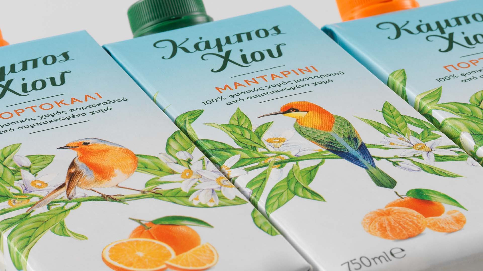 Close up photo on the illustrated front sides of Tetra Pak containers of Chios Gardens natural juices, with illustrations of various birds sitting on citrus tree branches