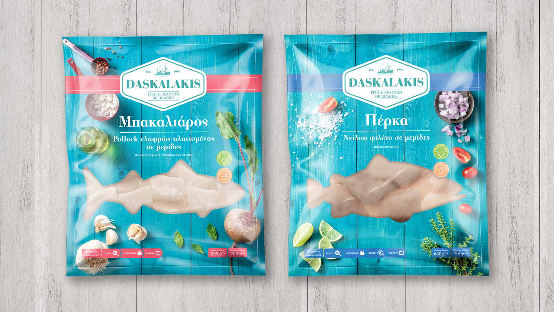 A product pair of Daskalakis Fresh Seafood Delicacies, showing the rebranded vacuum-sealed packaging for Pollock (Μπακαλιάρος) and Nile Perch (Πέρκα) on a white wood background.