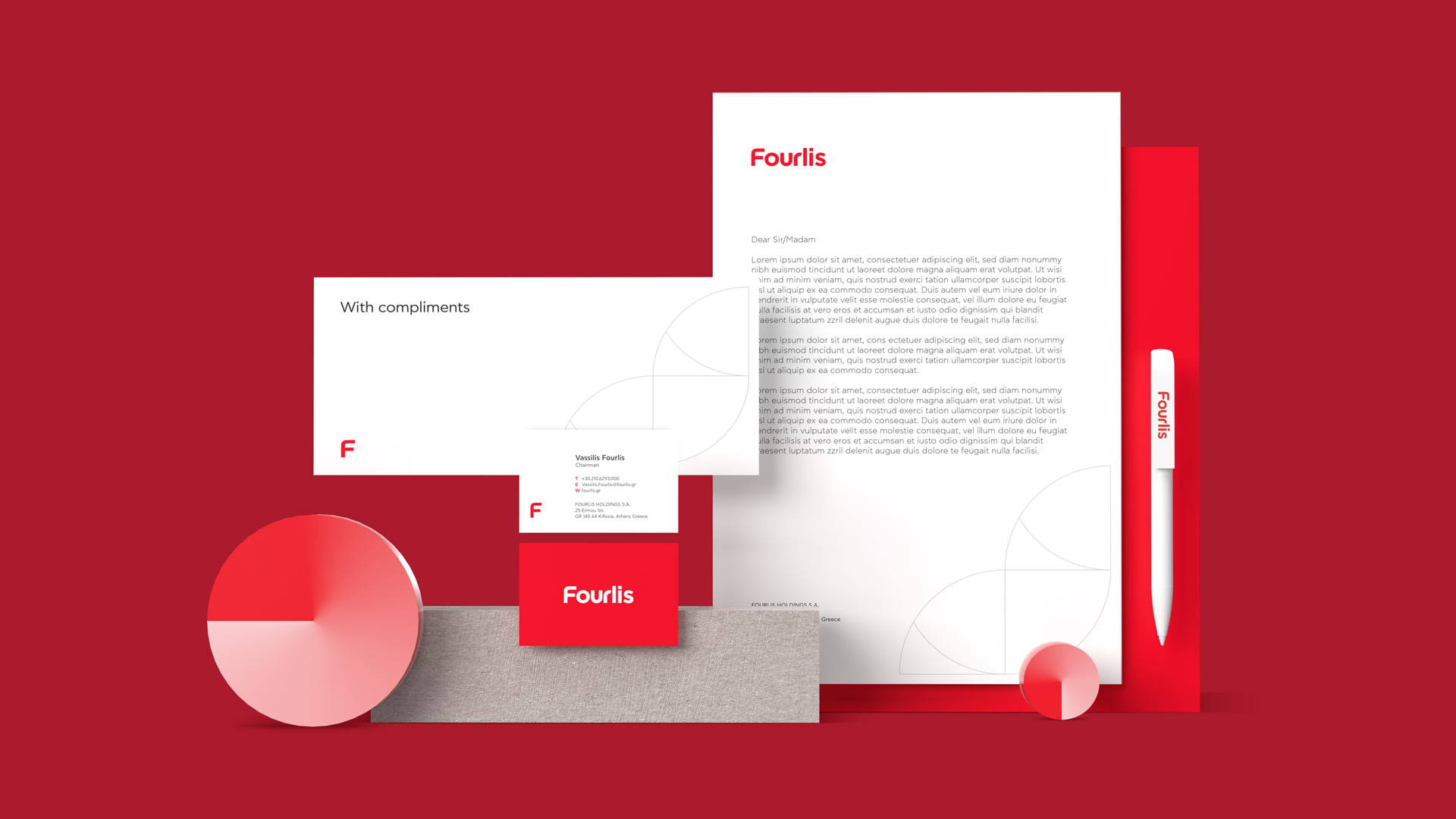 A flat lay of the Fourlis corporate stationery, including a letterhead, business card, compliment slip, and branded pen, all featuring the new red logo and design elements.