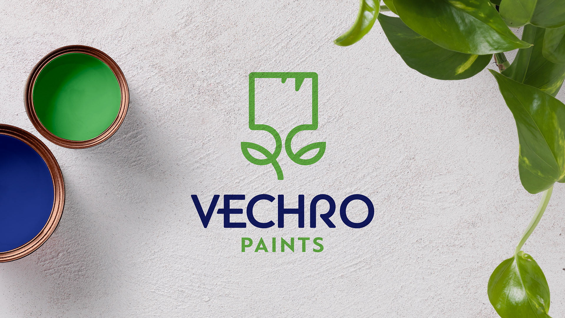A flat lay image of the VECHRO PAINTS logo, featuring a green, stylized icon of a paint can and leaf, set next to two open paint cans (blue and green) and a green plant, all on a white textured surface.